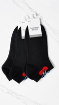 Black socks with red accents on a white surface, featuring a brand tag.